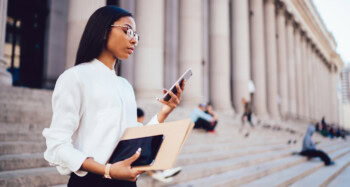 Law student in glasses on stairs of court building
